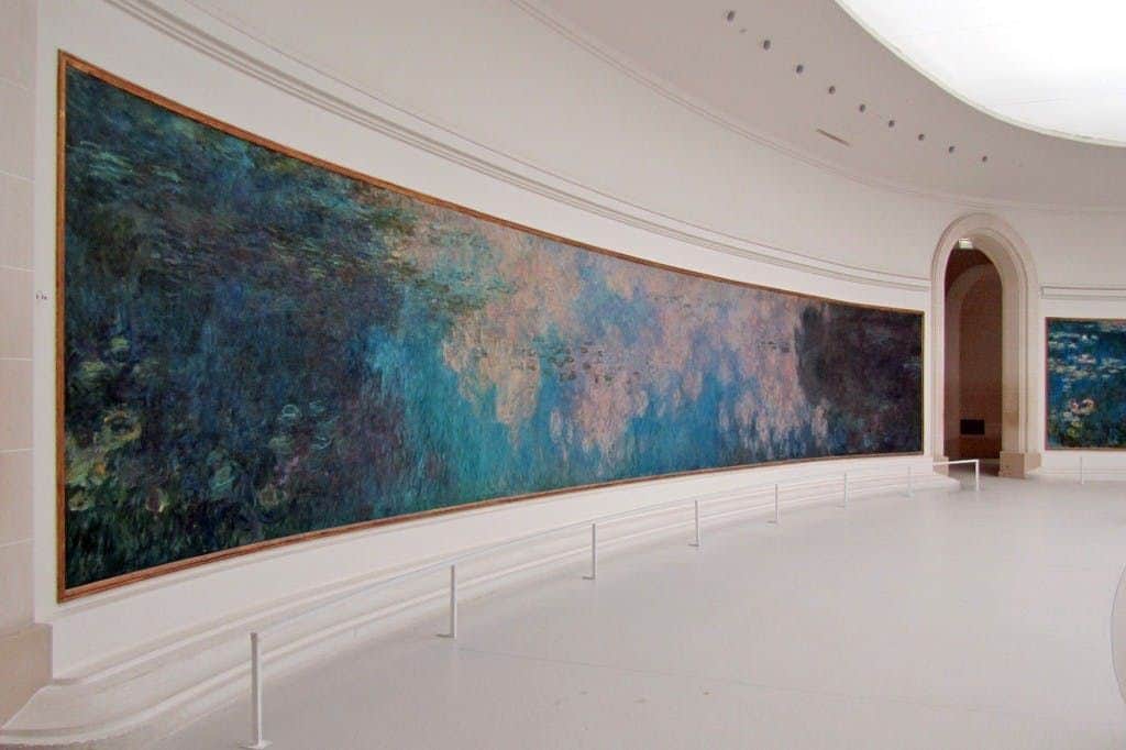 Musée de l'Orangerie: Private Guided Tour A large, panoramic painting with abstract blue and green tones displayed in a spacious, white-walled gallery.