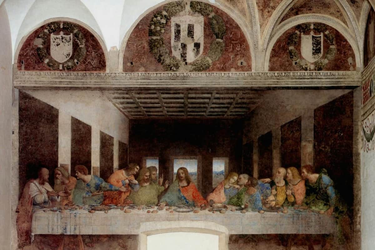 The Last Supper: Skip The Line Ticket + Guided Tour A famous mural painting depicting Jesus and his disciples seated at a long table in a large, arched room with ornate wall decorations.
