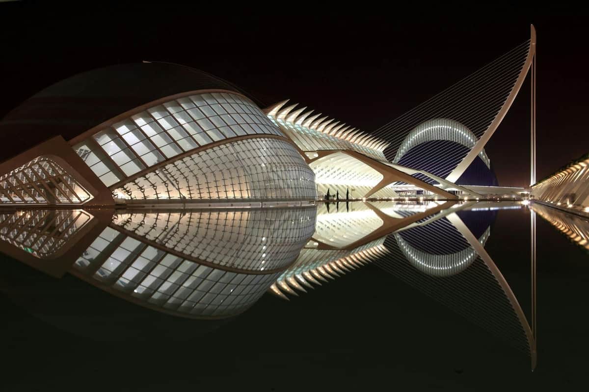 Oceanogràfic & Hemisfèric: Entry Ticket Futuristic, illuminated architectural structures at night with their reflections in still water.