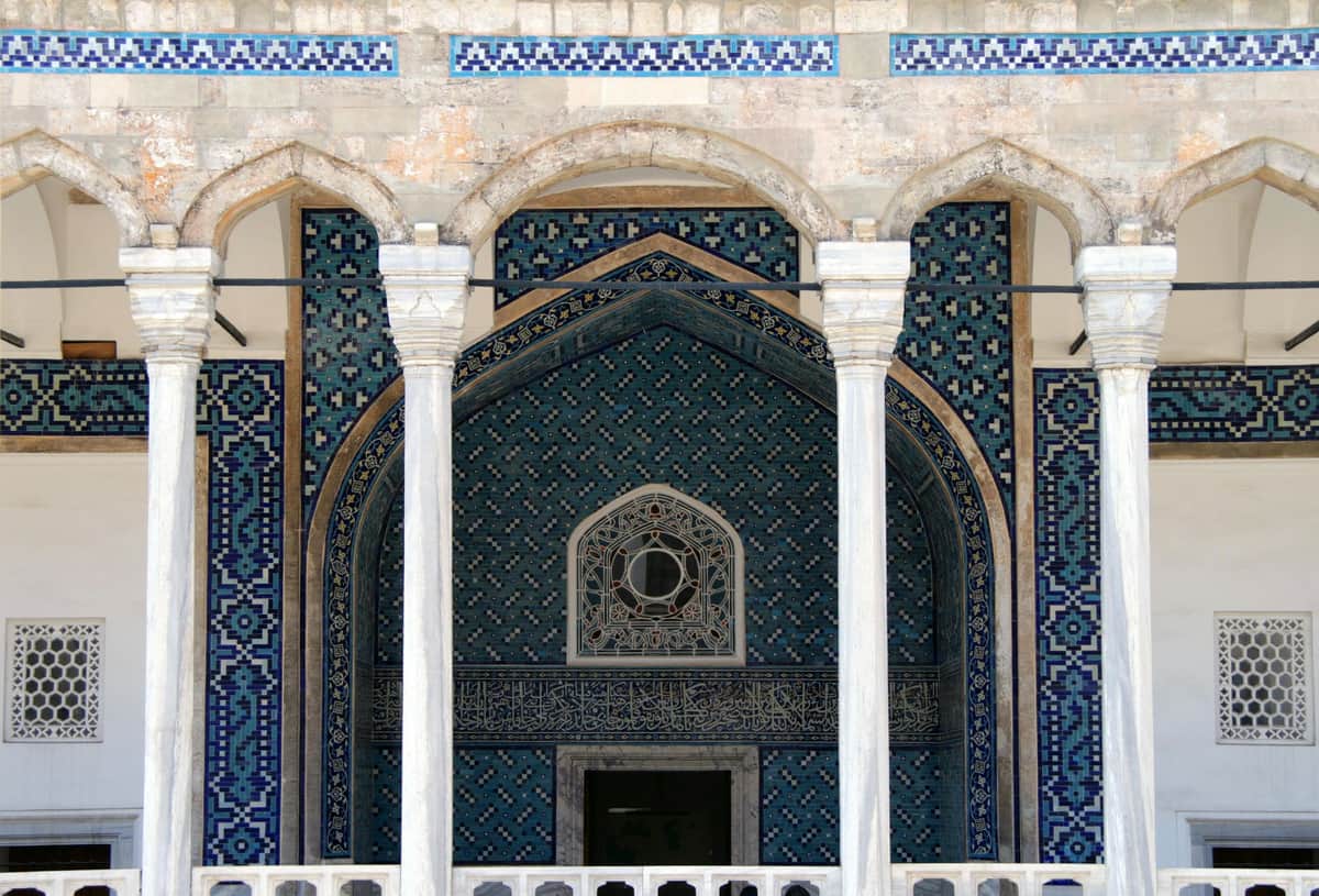 Turkish and Islamic Arts Museum: Skip The Line Ticket + Audio Guide Ornate building facade with blue and green geometric tile patterns, arched windows, and white stone columns.