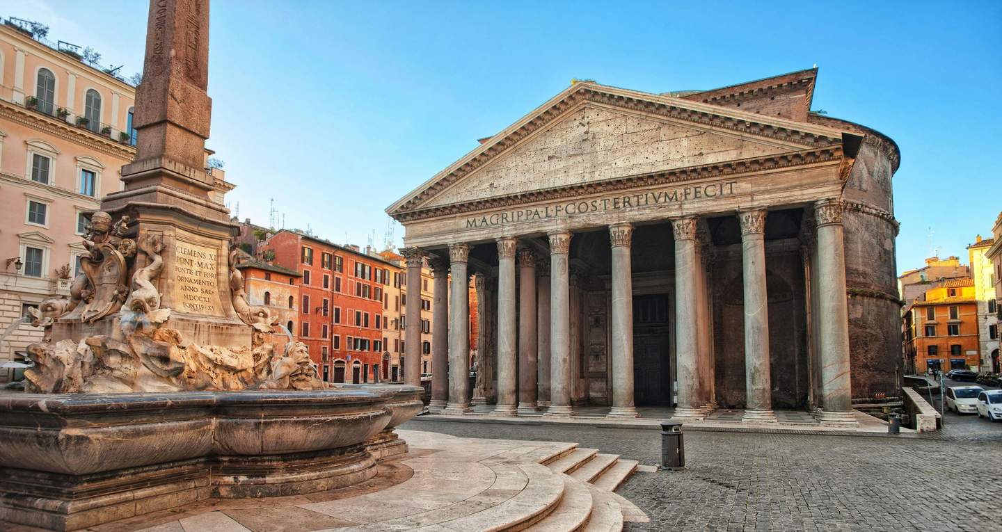 Rome Pantheon Historic stone building with large columns and a triangular pediment, adjacent to a stone fountain with sculpted figures.