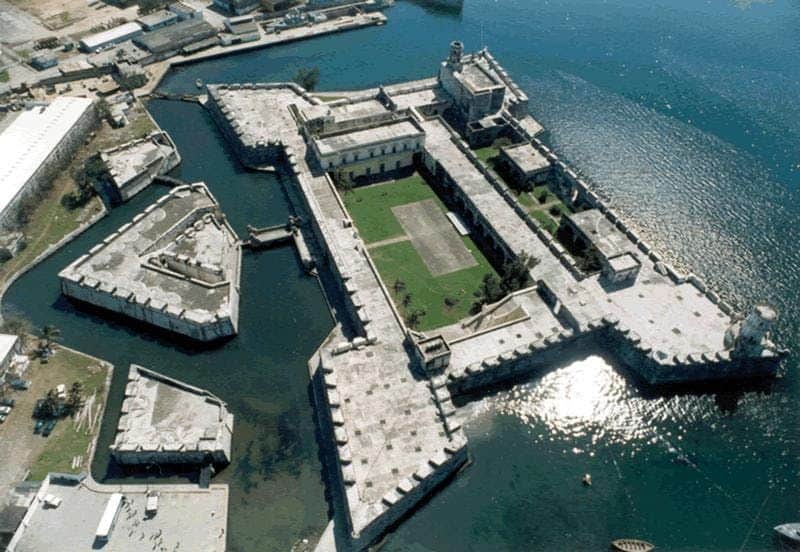 San Juan de Ulúa Aerial view of a large, star-shaped historic fortress surrounded by water, with a green courtyard and several buildings.