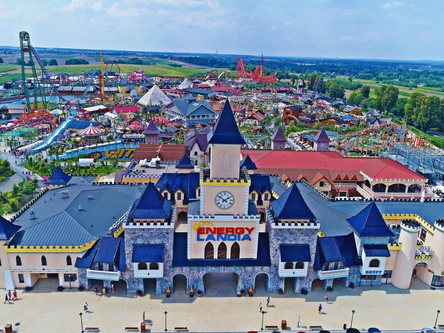 Energylandia Aerial view of an amusement park with roller coasters, a water slide, and colorful buildings. Sign reads "Energylandia."