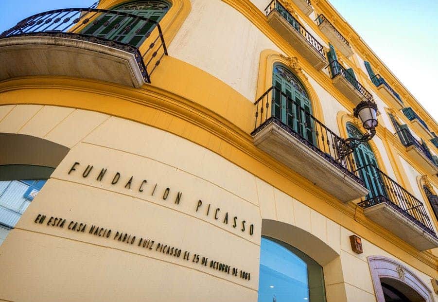 Picasso Birthplace Museum Yellow building with green balconies, sign reading "Fundación Picasso" and text indicating Picasso's birthplace, Málaga.
